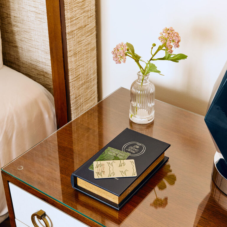 The Oliver Hotel Nesting Book With Key Card On Nightstand